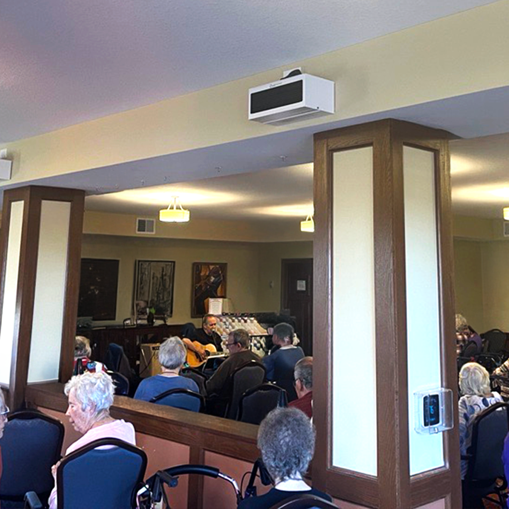 UV-FLOW-WL wall-mounted upper-room UV-C unit installed in a senior living activity room